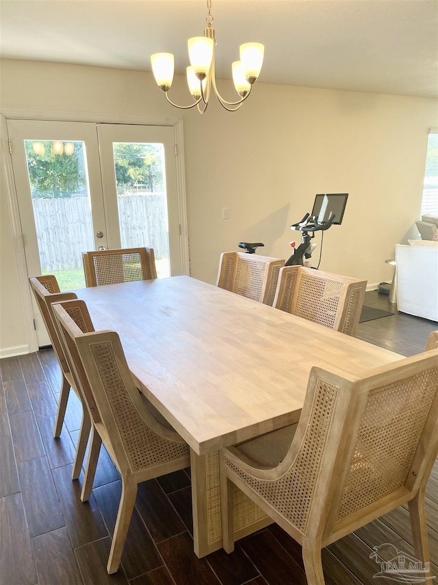 dining area with french doors and a notable chandelier