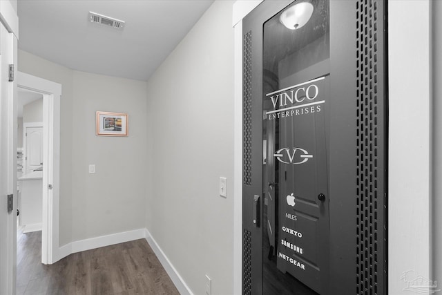 corridor with hardwood / wood-style flooring