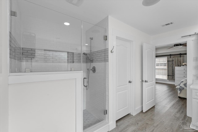 bathroom with hardwood / wood-style floors and walk in shower