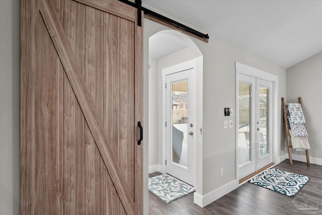 doorway to outside with wood-type flooring and a barn door