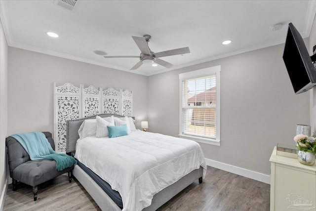 bedroom featuring wood-type flooring, ornamental molding, and ceiling fan