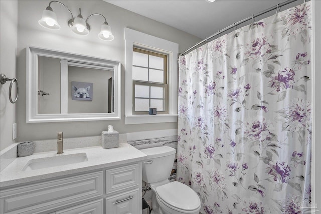 bathroom with a shower with curtain, vanity, and toilet