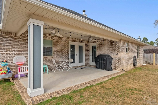 exterior space with a patio, a lawn, and french doors