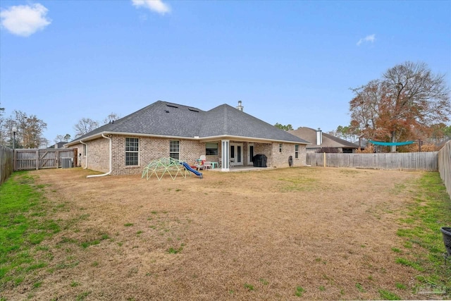 rear view of property with a patio area and a lawn