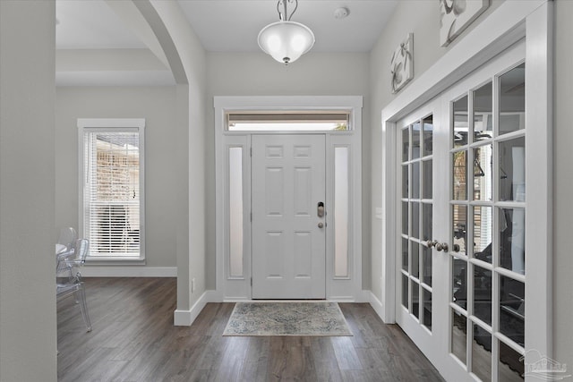 foyer featuring dark hardwood / wood-style floors and french doors