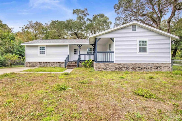 single story home with covered porch and a front lawn