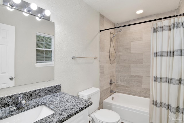 full bathroom with vanity, shower / bath combination with curtain, and toilet