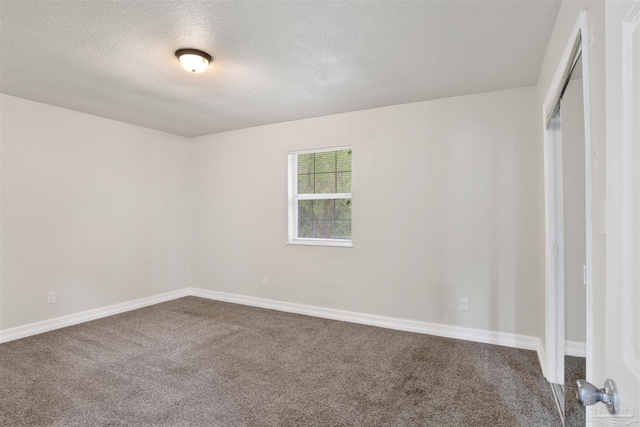 interior space with a textured ceiling and carpet floors