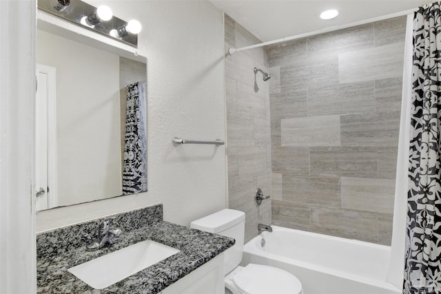 full bathroom featuring shower / tub combo with curtain, vanity, and toilet