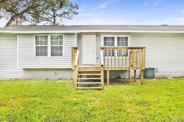 exterior space with a lawn, central AC, and a deck