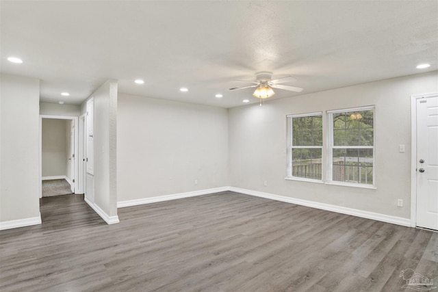 unfurnished room featuring ceiling fan and dark hardwood / wood-style flooring