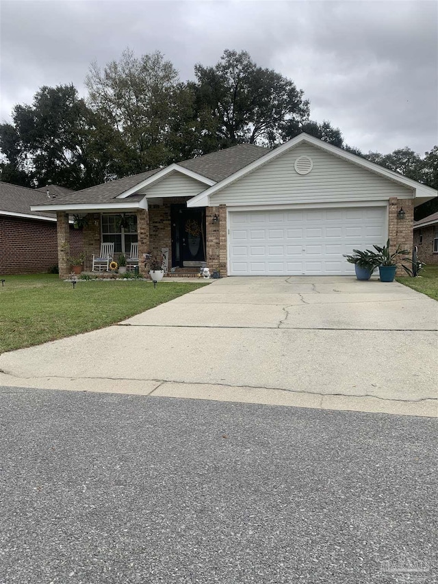 ranch-style house featuring covered porch, concrete driveway, a front yard, an attached garage, and brick siding