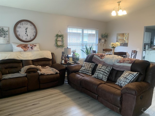 living area featuring a chandelier and light wood finished floors