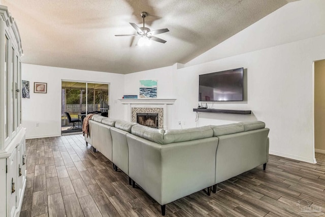 living room featuring a textured ceiling, dark hardwood / wood-style floors, and vaulted ceiling