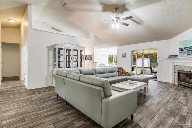 living room featuring a textured ceiling, vaulted ceiling, and dark wood-type flooring