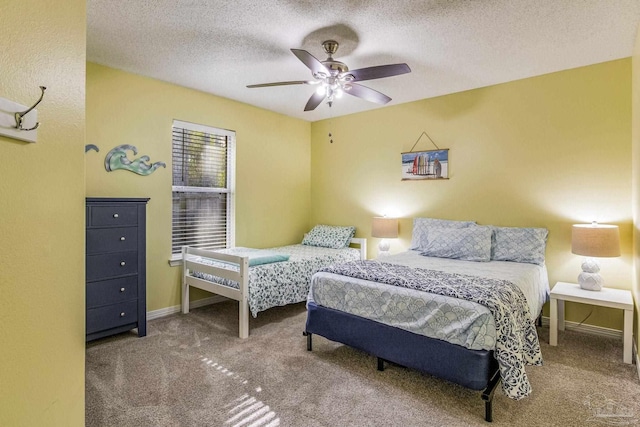 carpeted bedroom featuring a textured ceiling and ceiling fan