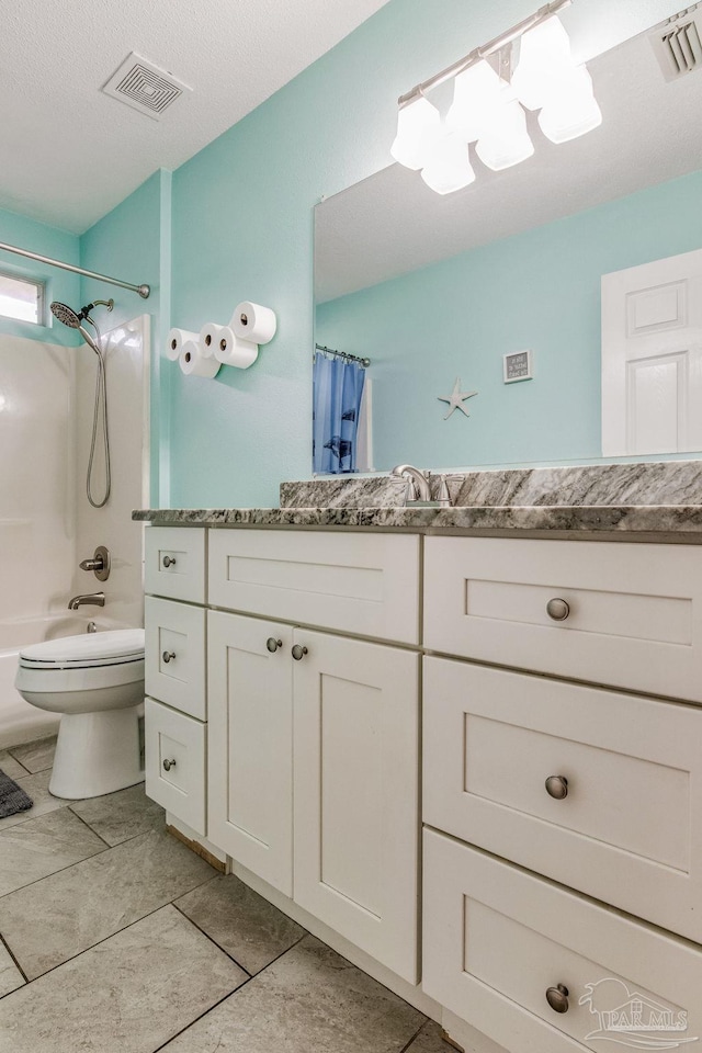 full bathroom featuring a textured ceiling, vanity, shower / tub combo with curtain, tile patterned flooring, and toilet