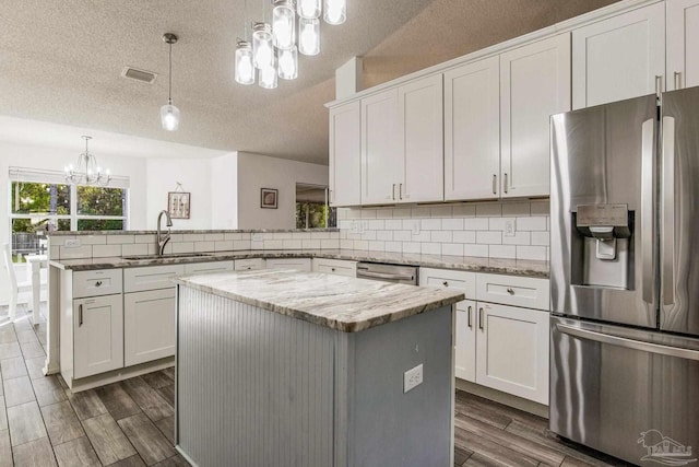 kitchen with white cabinetry, sink, a center island, and appliances with stainless steel finishes