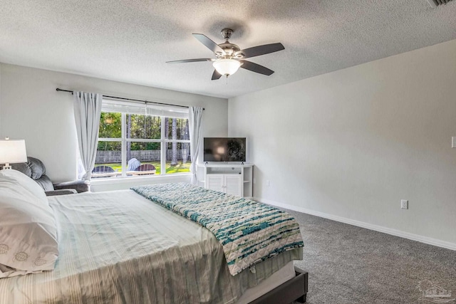 carpeted bedroom with ceiling fan and a textured ceiling