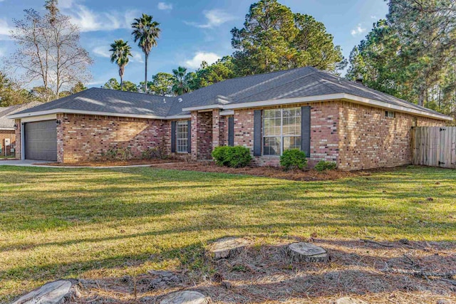 ranch-style house featuring a front yard and a garage