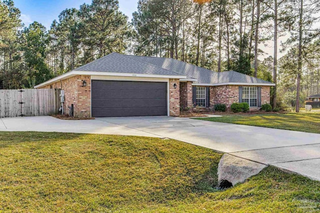 single story home featuring a garage and a front yard