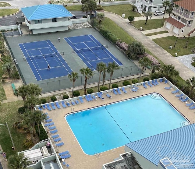 view of pool with a tennis court and fence