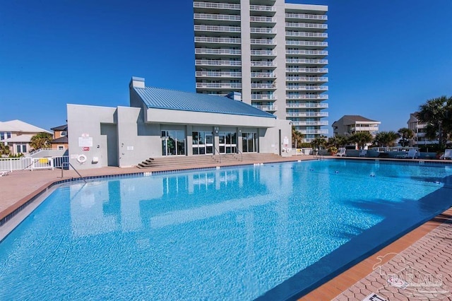 community pool featuring a patio area and fence