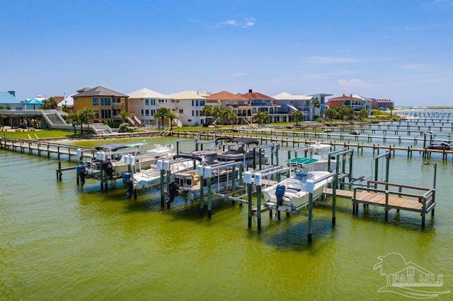 view of dock with a water view, boat lift, and a residential view