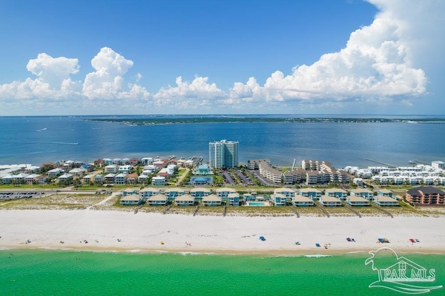 aerial view with a water view and a beach view