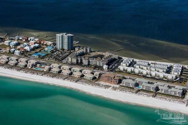 birds eye view of property featuring a beach view and a water view