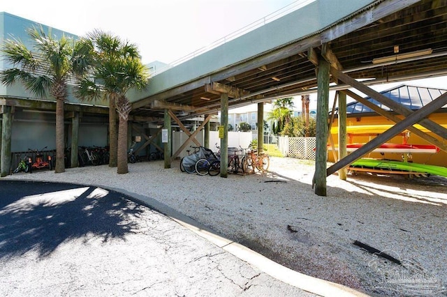 view of vehicle parking featuring fence