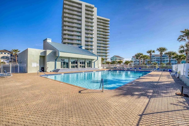 pool with fence and a patio