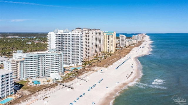 birds eye view of property featuring a view of the beach, a water view, and a view of city