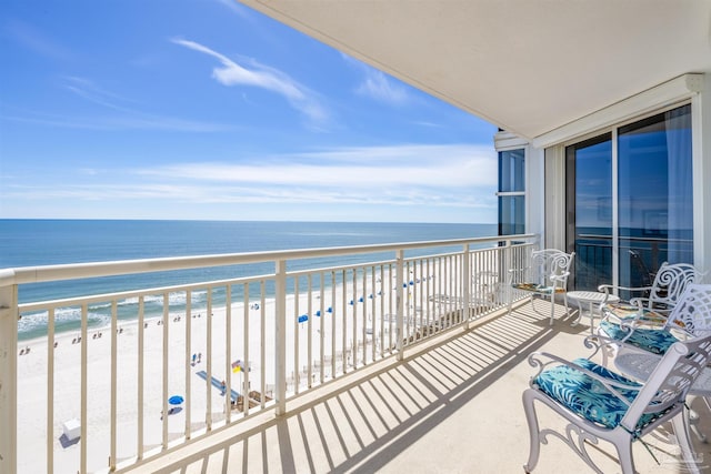 balcony with a view of the beach and a water view