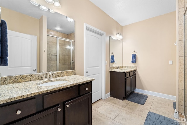 1824 Lindsey Magnolia Ct, Navarre, FL 32566 - bathroom with a stall shower, two vanities, baseboards, and tile patterned flooring