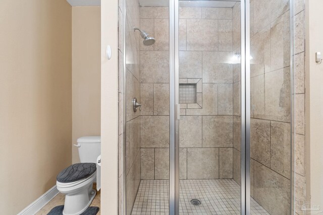 1824 Lindsey Magnolia Ct, Navarre, FL 32566 - bathroom featuring a shower stall, toilet, and baseboards