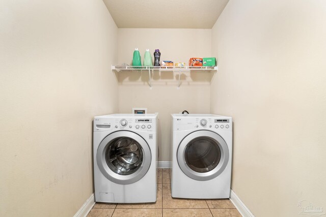 1824 Lindsey Magnolia Ct, Navarre, FL 32566 - washroom with washing machine and clothes dryer, light tile patterned flooring, and baseboards