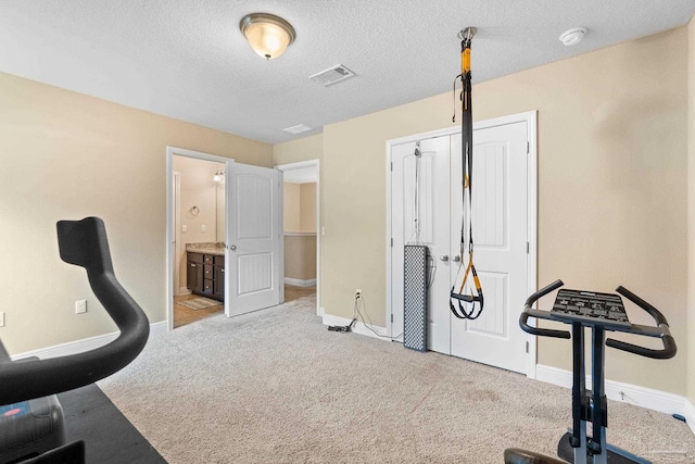 1824 Lindsey Magnolia Ct, Navarre, FL 32566 - workout room featuring carpet floors, baseboards, and a textured ceiling