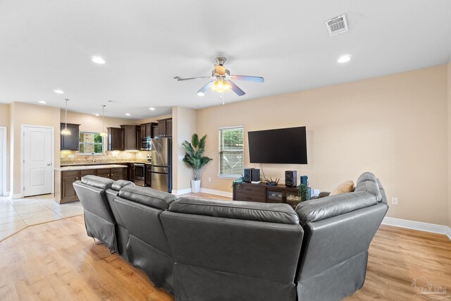 1824 Lindsey Magnolia Ct, Navarre, FL 32566 - living room with ceiling fan, healthy amount of natural light, baseboards, recessed lighting, and light wood-style flooring