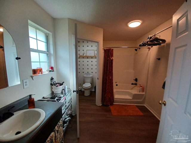 full bathroom with shower / tub combo with curtain, vanity, toilet, and hardwood / wood-style floors