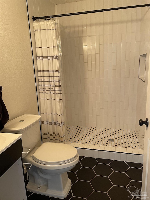 bathroom with vanity, toilet, tile patterned flooring, and a shower with shower curtain