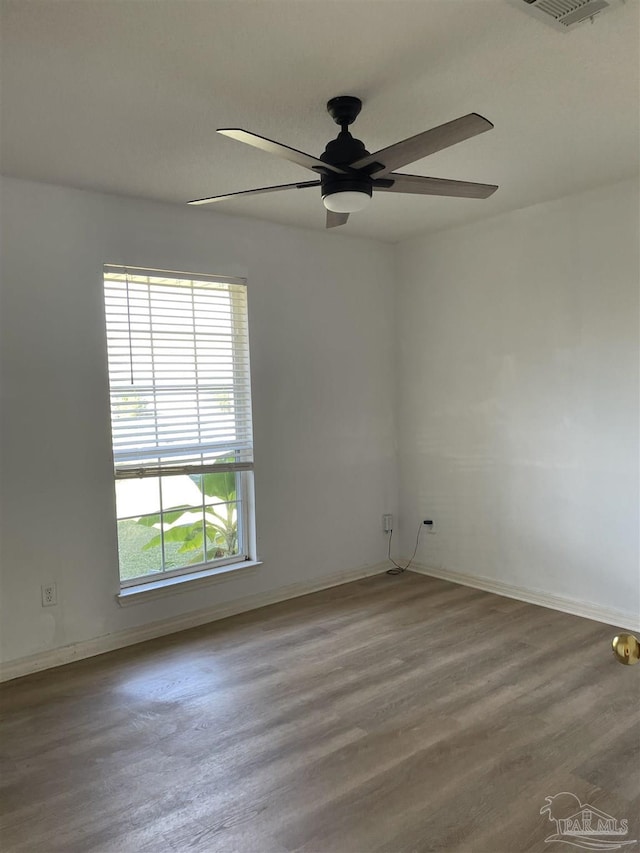 spare room with hardwood / wood-style flooring and ceiling fan