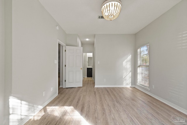 spare room featuring light hardwood / wood-style floors