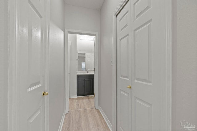 hallway featuring light hardwood / wood-style floors and sink