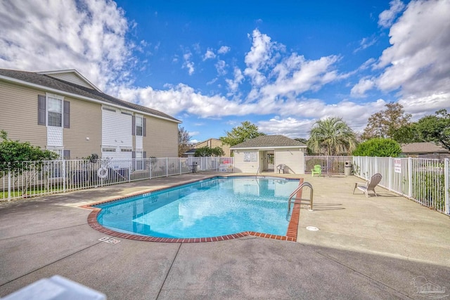 view of pool with a patio area and an outdoor structure