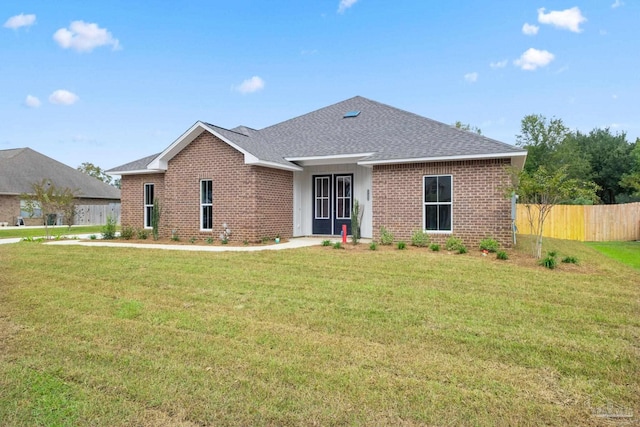 ranch-style home featuring a front yard