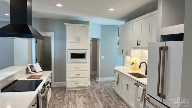 kitchen featuring white cabinets, stainless steel appliances, exhaust hood, and sink