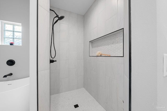 bathroom featuring a tile shower