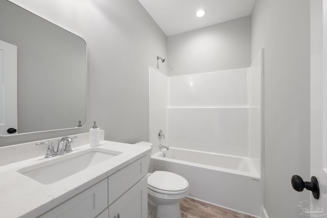 full bathroom featuring vanity, hardwood / wood-style flooring, toilet, and shower / bathtub combination