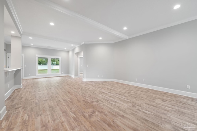 unfurnished living room featuring ornamental molding, beamed ceiling, and light wood-type flooring